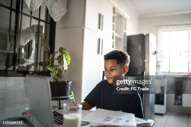boy studying using laptop at home - taking standardized test stock pictures, royalty-free photos & images