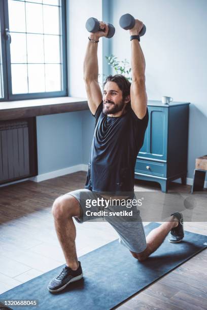 young men exercising at home - dumbells isolated stock pictures, royalty-free photos & images