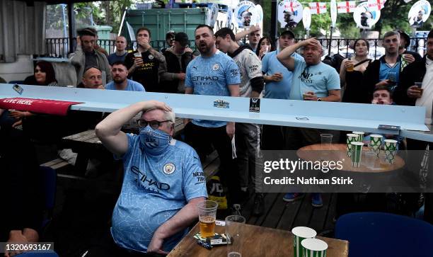 Manchester City fans react as Chelsea score the opening goal as they watch the UEFA Champions League Final between Manchester City and Chelsea in a...