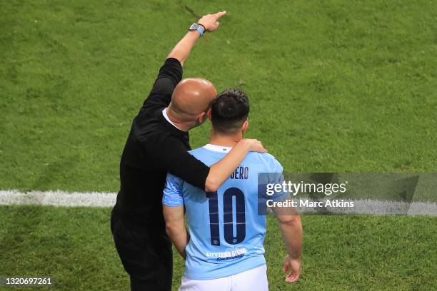 Pep Guardiola, Manager of Manchester City gives instructions to Sergio Aguero of Manchester City as he prepares to be substituted on during the UEFA...