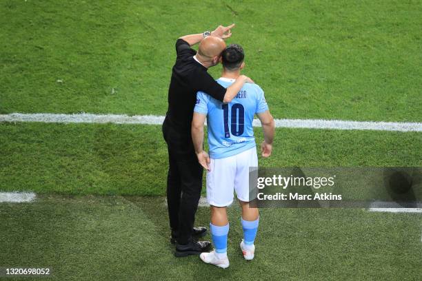 Pep Guardiola, Manager of Manchester City gives instructions to Sergio Aguero of Manchester City as he prepares to be substituted on during the UEFA...