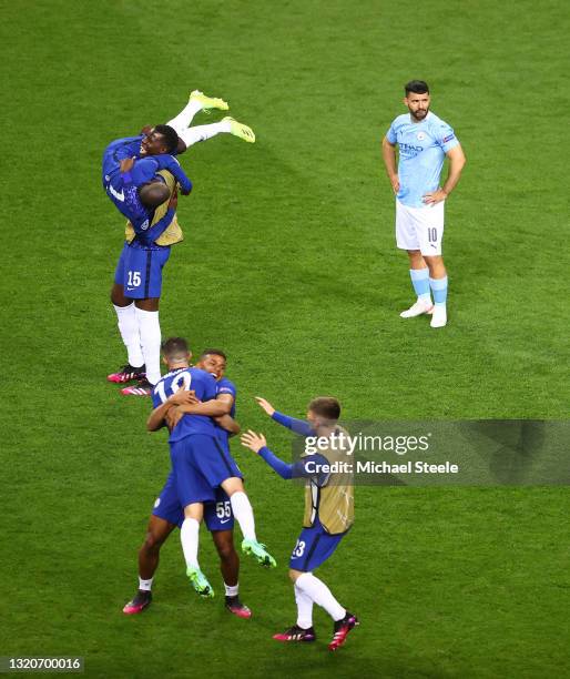 Players of Chelsea celebrate as Sergio Aguero of Manchester City looks dejected following their side's victory in the UEFA Champions League Final...