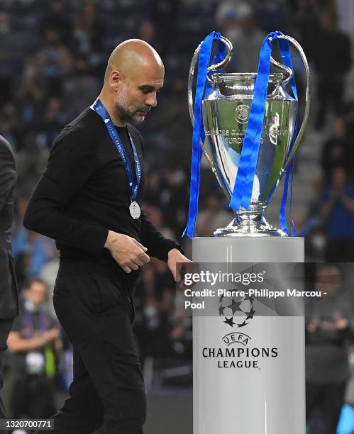 Pep Guardiola, Manager of Manchester City walks past the UEFA