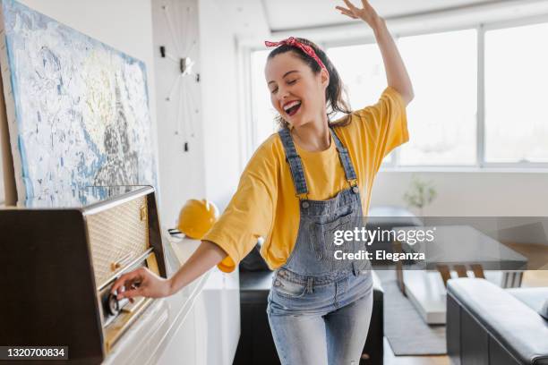 woman having fun, singing, dancing and listening music at home - 20 years old dancing stock pictures, royalty-free photos & images