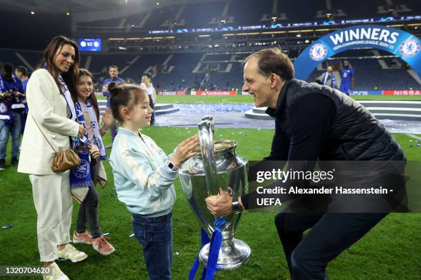 Thomas Tuchel, Manager of Chelsea poses with family and the Champions League Trophy following their team's victory in the UEFA Champions League Final...