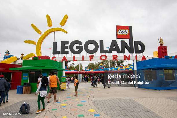 Visitors make their way into LEGOLAND for the Grand Opening of The Lego Movie World at LEGOLAND California on May 29, 2021 in Carlsbad, California.
