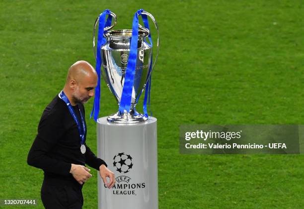 Pep Guardiola, Manager of Manchester City leaves the pitch with their runners up medal following the UEFA Champions League Final between Manchester...