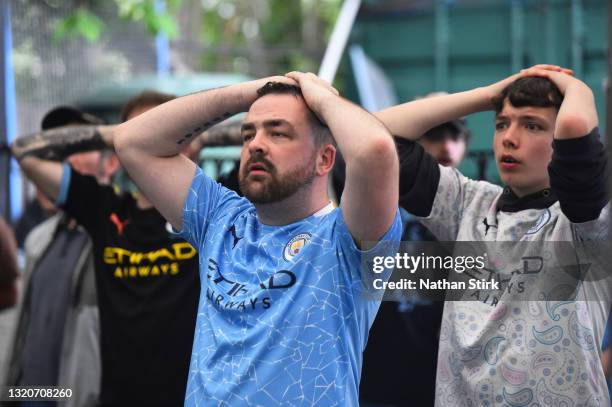 Manchester City fans react as they watch the UEFA Champions League Final between Manchester City and Chelsea in a bar on May 29, 2021 in Manchester,...