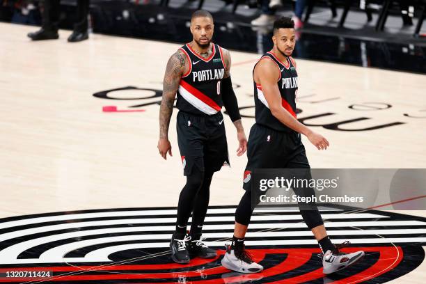 Damian Lillard and CJ McCollum of the Portland Trail Blazers look on in the third quarter against the Denver Nuggets during Round 1, Game 4 of the...