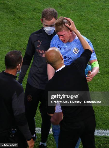 Pep Guardiola the manager of Manchester City checks on Kevin De Bruyne of Manchester City as he is assisted off the pitch and substituted after an...