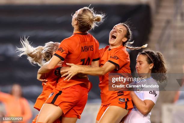 Kristie Mewis of Houston Dash jumps into the arms of Rachel Daly and Gabby Seiler to celebrate her goal during the second half against the Chicago...