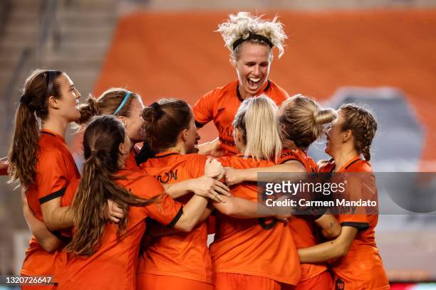 Sophie Schmidt of Houston Dash jumps into teammates to celebrate a goal by Kristie Mewis during the second half against the Chicago Red Stars at BBVA...