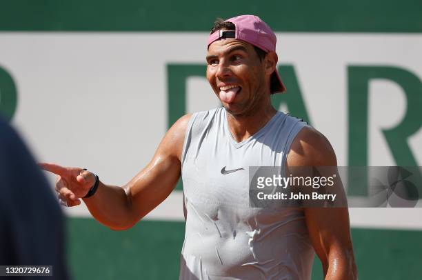 Rafael Nadal of Spain jokes with Iga Swiatek of Poland he's practicing with ahead of the French Open 2021, Grand Slam tennis tournament at...