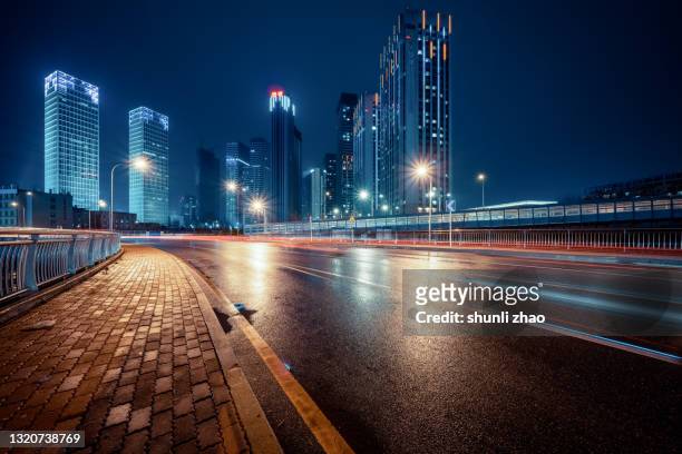 city street after the rain - city street night background stock pictures, royalty-free photos & images