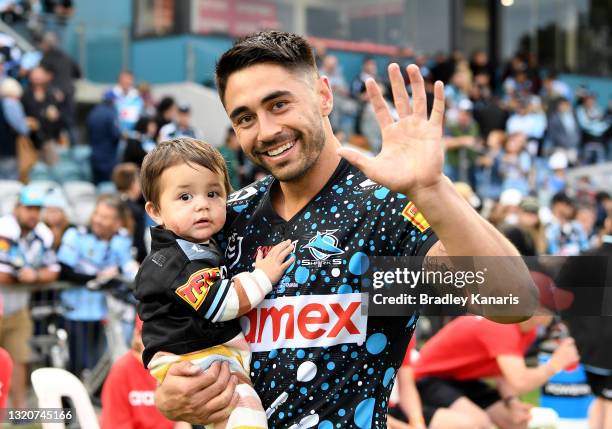 Shaun Johnson of the Sharks celebrates victory and his 200th NRL match with daughter Millah Johnson after the round 12 NRL match between the Cronulla...