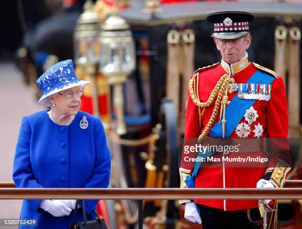 Queen Elizabeth II and Prince Edward, Duke of Kent stand on a dais outside Buckingham Palace during the annual Trooping the Colour Ceremony on June...