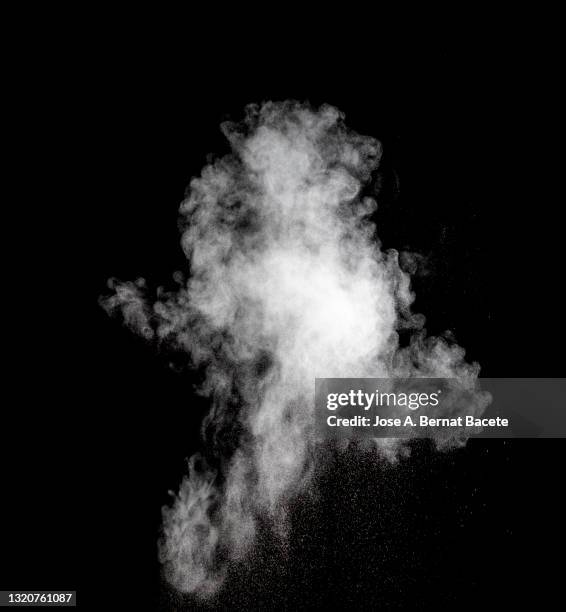 explosion of a cloud of particles of smoke of white color on a black background. - smoke black background ストックフォトと画像