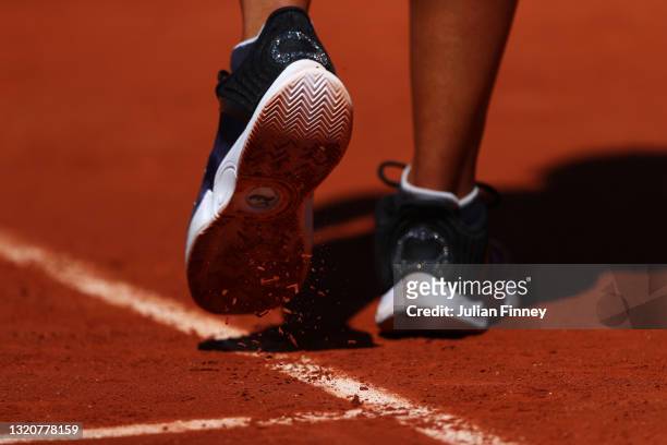 Detailed view as clay falls off the Nike shoes of Naomi Osaka of Japan in her First Round match against Patricia Maria Tig of Romania during Day One...