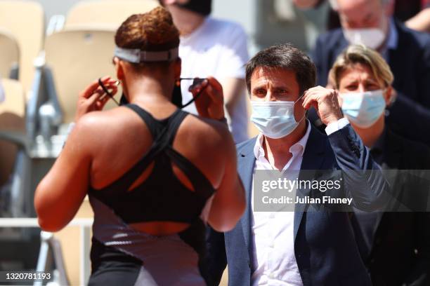 Fabrice Santoro talks with Naomi Osaka of Japan to ask her to be interviewed on court after winning her First Round match against Patricia Maria Tig...