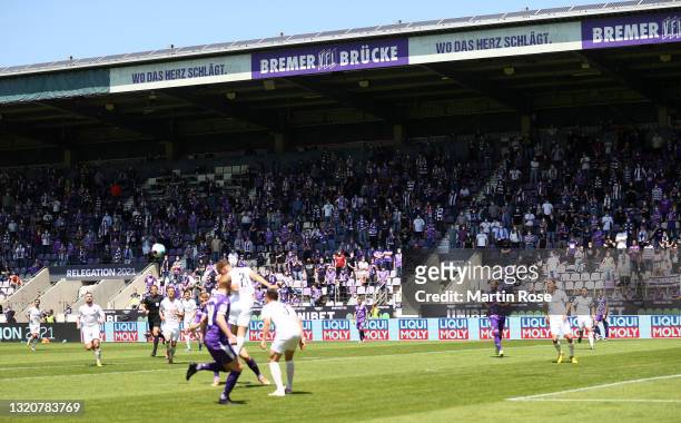 Fans watch on from the stands as Tobias Schrock of FC Ingolstadt heads clear during the 2. Bundesliga playoff leg two match between VfL Osnabrück and...