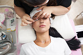 lash laminating and painting, closeup face. Beauty procedures in cosmetology clinic