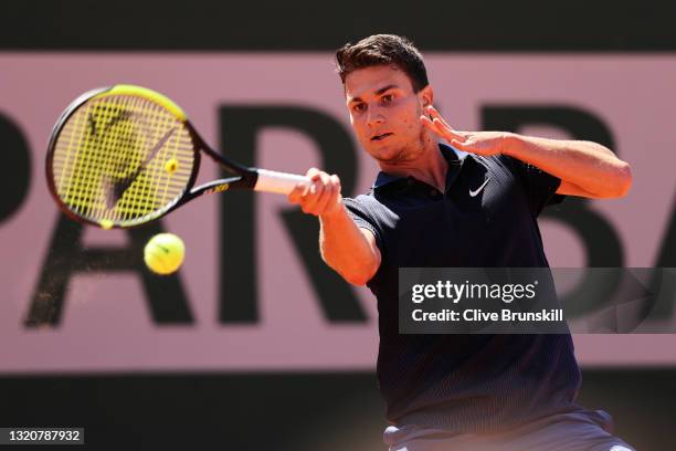 Miomir Kecmanovic of Serbia plays a forehand in his First Round match against Dan Evans of Great Britain during Day One of the 2021 French Open at...