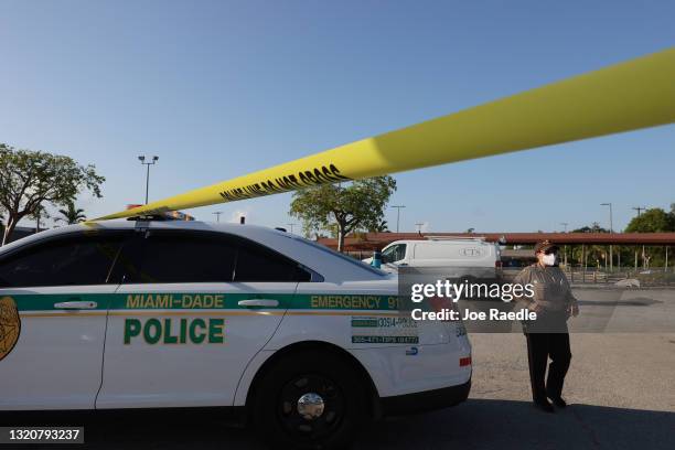 Miami-Dade police officer stands near where a mass shooting took place outside of a banquet hall on May 30, 2021 in Hialeah, Florida. Police say that...