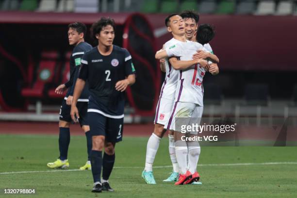 Wu Xi of China celebrates a point with teammate during the FIFA World Cup Asian qualifier Group A second round match between China and Guam at Suzhou...