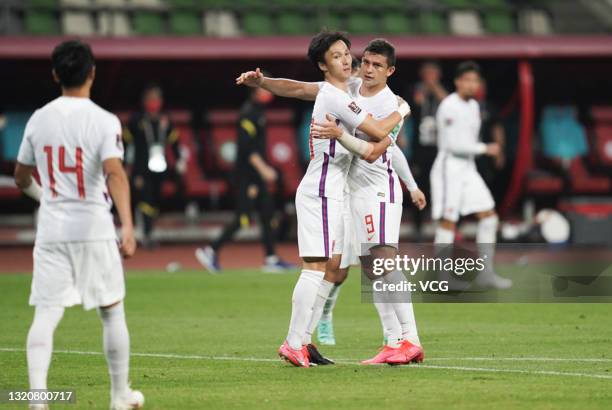 Elkeson of China celebrates a point with Yin Hongbo of China during the FIFA World Cup Asian qualifier Group A second round match between China and...