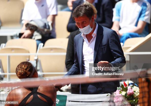 Fabrice Santoro talks with Naomi Osaka of Japan to ask her to be interviewed on court after winning her First Round match against Patricia Maria Tig...