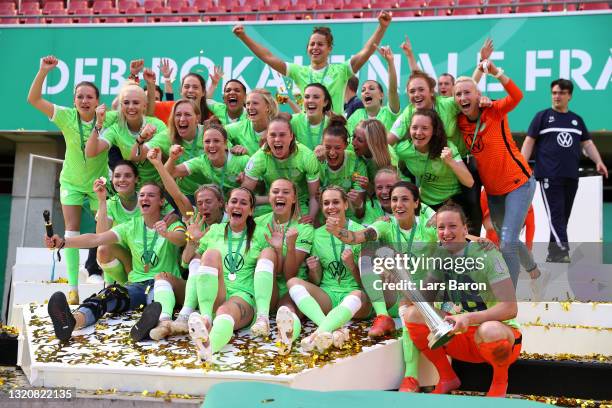 Players of VfL Wolfsburg celebrate with the DFB Cup following victory in the Women's DFB Cup Final match between Eintracht Frankfurt and VfL...