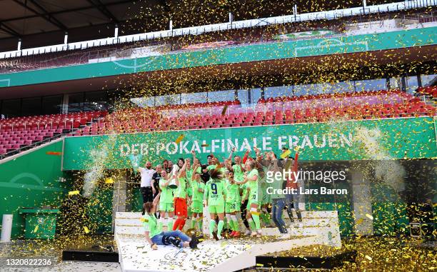 Svenja Huth of VfL Wolfsburg lifts the DFB Cup as their team mates celebrate victory in the Women's DFB Cup Final match between Eintracht Frankfurt...