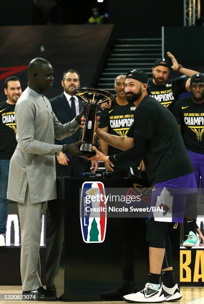 Omar Hesham of Zamalek receives the Championship Trophy from president Amadou Gallo Fall BAL the BAL after Zamalek won the Basketball Africa League...