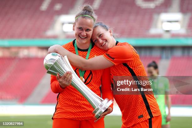 Friederike Abt and Almuth Schult of VfL Wolfsburg pose with the DFB Cup following victory in the Women's DFB Cup Final match between Eintracht...