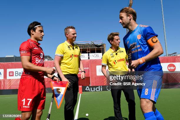 Thomas Briels of Belgium, umpire Coen van Bunge, umpire Jonas van t Hek and Billy Bakker of the Netherlands during the Mens FIH Pro League match...
