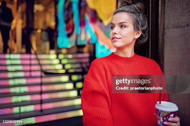 young woman is exiting from a mall - living beauty the gift photo exhibit stock pictures, royalty-free photos & images
