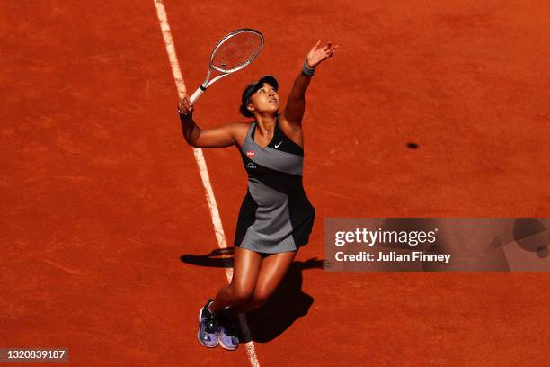 Naomi Osaka of Japan serves in her First Round match against Patricia Maria Tig of Romania during Day One of the 2021 French Open at Roland Garros on...