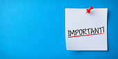 White Sticky Note With Important And Red Push Pin On Blue Background