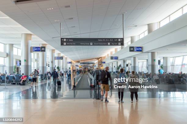 arrival and departure gates in the new salt lake city airport - crowded airplane stock pictures, royalty-free photos & images