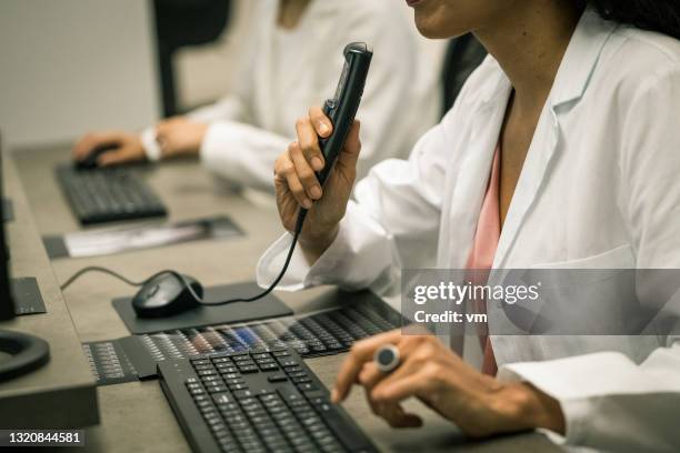 cropped view of female hand holding voice recorder. - dictaphone stock pictures, royalty-free photos & images