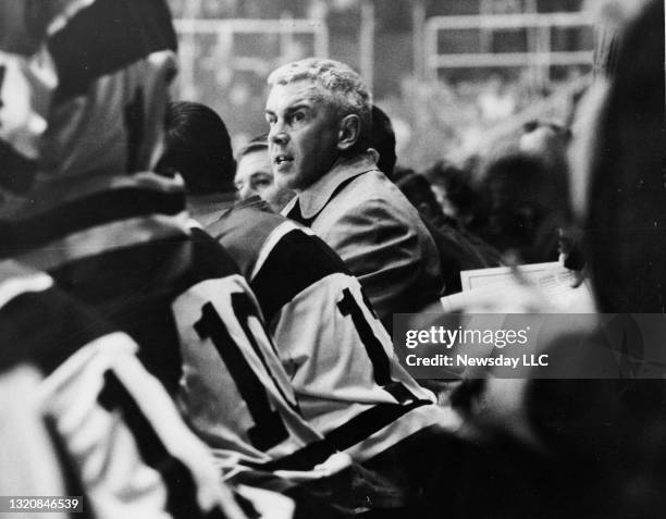John Brophy, new coach of the Long Island Ducks hockey team, watches the game action from the sidelines at the Commack Arena in Commack, New York on...