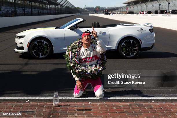 Helio Castroneves of Brazil, driver of the AutoNation/SiriusXM Meyer Shank Racing Honda, celebrates by kissing the yard of bricks after winning the...