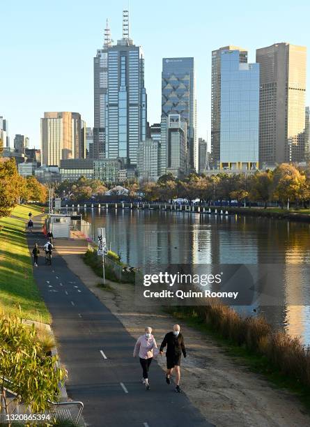 People get their morning exercise walking alongside the Yarra River on May 31, 2021 in Melbourne, Australia. Lockdown restrictions remain in place...