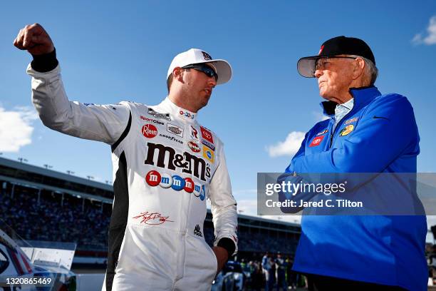 Kyle Busch, driver of the M&M's Red White & Blue Toyota, and Hall of Famer and team owner Joe Gibbs talk on the grid prior to the NASCAR Cup Series...