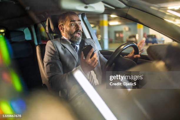 terrified businessman having a car accident while using cell phone. - distracted driving stock pictures, royalty-free photos & images