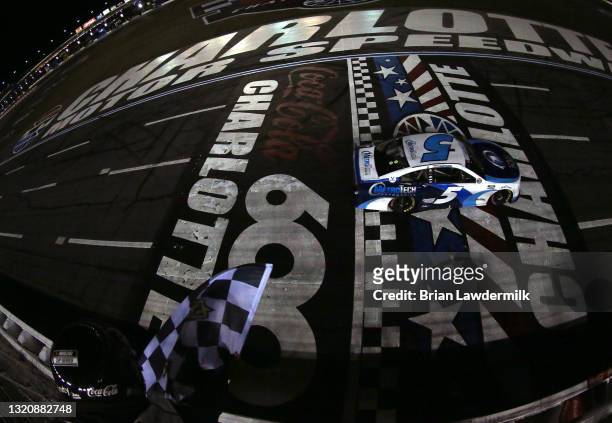 Kyle Larson, driver of the Metro Tech Chevrolet, crosses the finish line to win the NASCAR Cup Series Coca-Cola 600 at Charlotte Motor Speedway on...