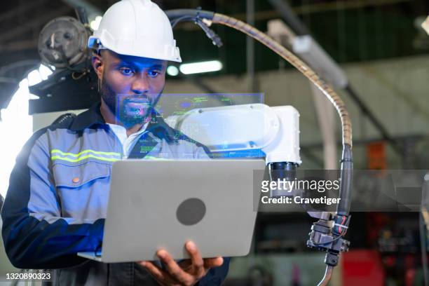 the inspection engineer check the mechanical parts before setting parts for welding in the robot units at metal factory. - matrix organisation stock pictures, royalty-free photos & images