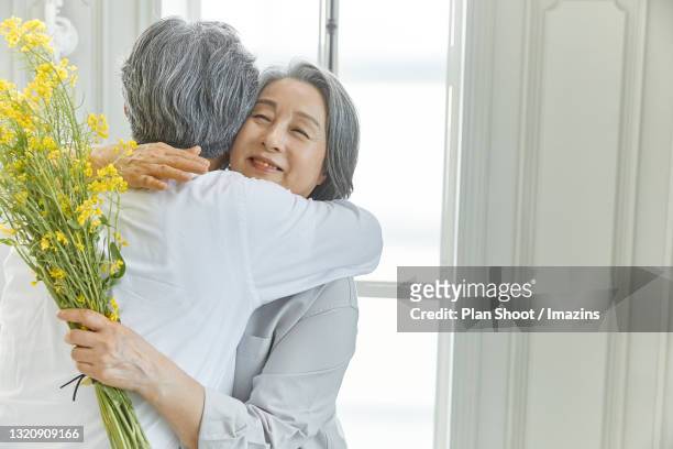 an old man giving flower to his wife - korean stock pictures, royalty-free photos & images