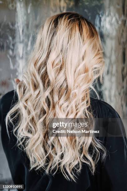 hairstyle of woman after hair styling - blonde hair dye stock pictures, royalty-free photos & images