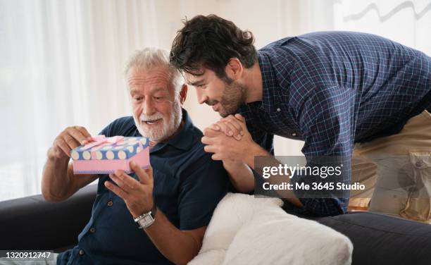 father and son with cake celebrate . relationship father and son adult. - father gift stock pictures, royalty-free photos & images